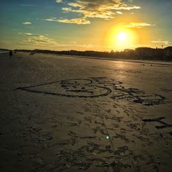Scenic view of beach against sky during sunset