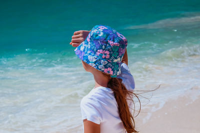 Rear view of woman standing on beach