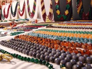 Close-up of multi colored necklace and decorative items for sale in market