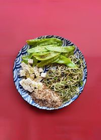 Directly above shot of food in bowl against red background