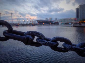 Close-up of metallic chain at harbor