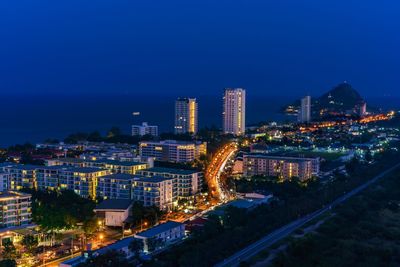 High angle view of illuminated buildings against sky at night