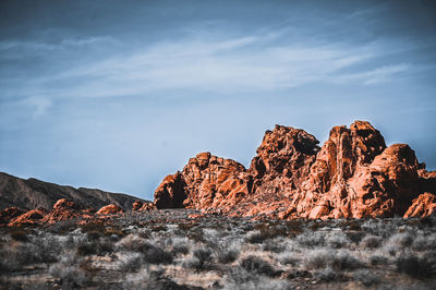 Rock formation in sea against sky