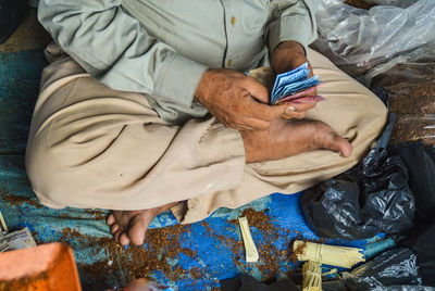 High angle view of man holding paper