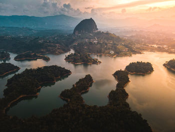 Sunset over the lakes around guatape colombia with the famous monolith.