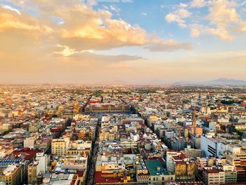 High angle shot of townscape against sky at sunset