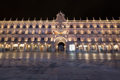 Illuminated building in city at night