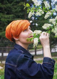 Portrait of young woman holding flower