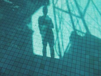 Shadow of people on tiled floor
