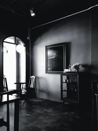 Empty chairs and tables in illuminated room