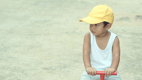 Baby boy riding toy bicycle