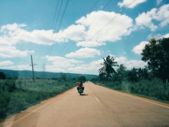 Man on road against sky