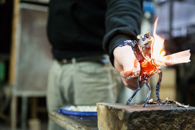 Man preparing vase in industry