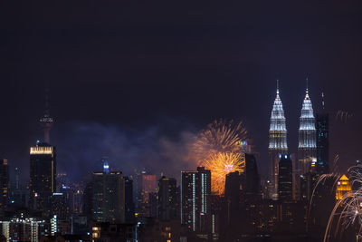 View of skyscrapers lit up at night