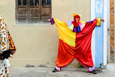 A person dressed up in venice carnival style has fun during the street carnival 