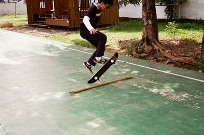 Side view of man skateboarding on skateboard