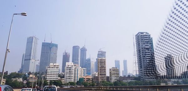 Modern buildings in city against clear sky