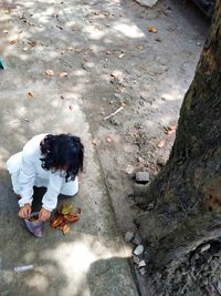 High angle view of woman sitting on road