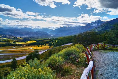 Scenic view of river by mountains against sky