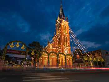 Low angle view of illuminated buildings against sky at night