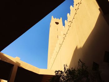 Low angle view of built structure against blue sky