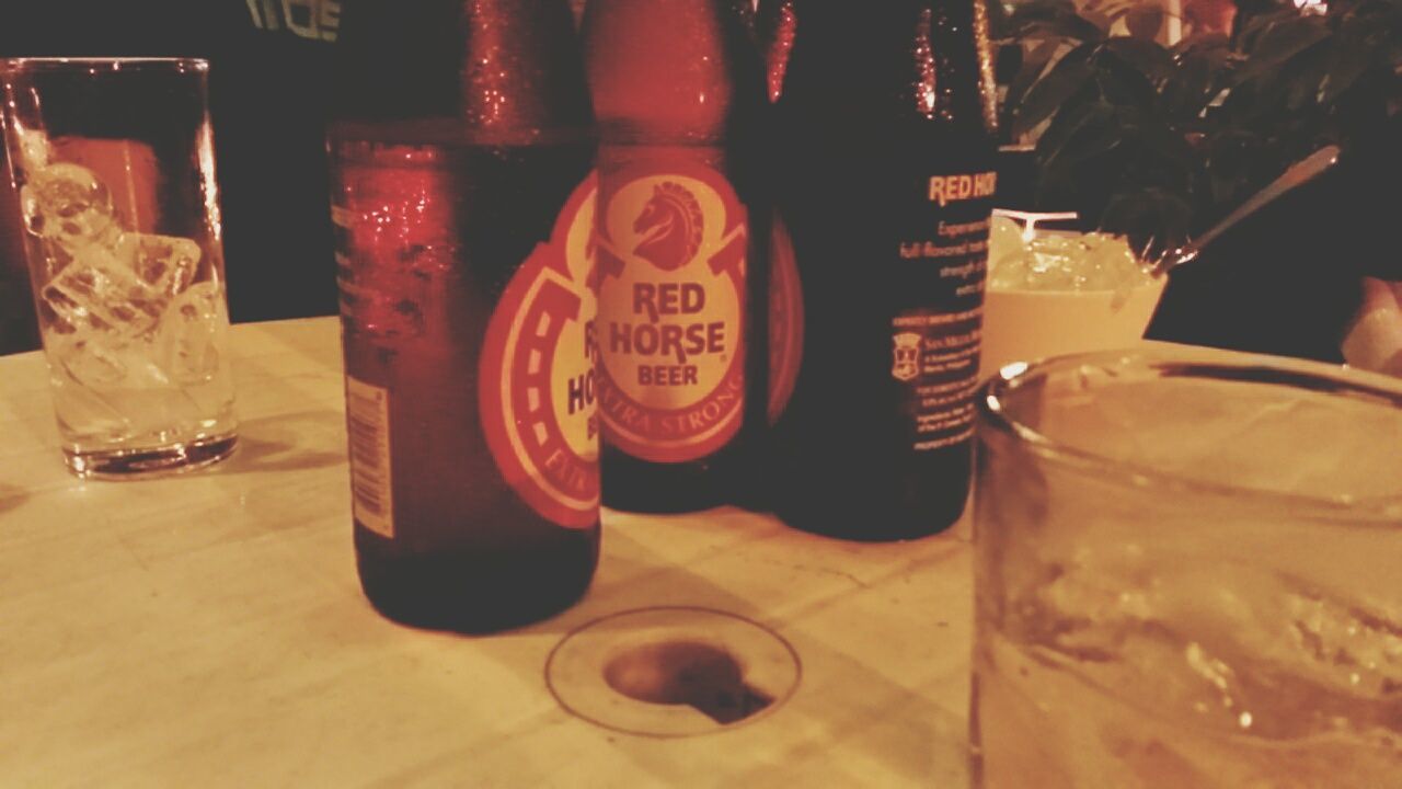 indoors, table, drink, food and drink, still life, refreshment, drinking glass, glass - material, close-up, freshness, alcohol, restaurant, no people, focus on foreground, text, transparent, jar, glass, bottle, selective focus