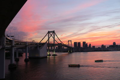 View of bridge over river during sunset