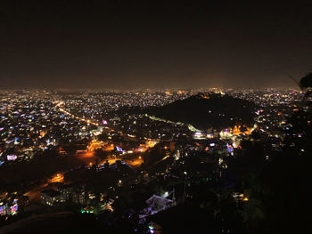 High angle view of illuminated buildings in city at night