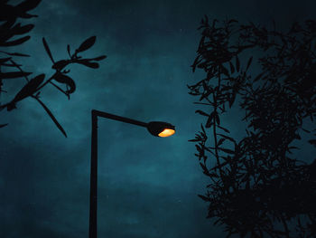 Low angle view of illuminated street light against sky at night