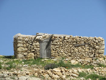 Old stone wall against clear sky