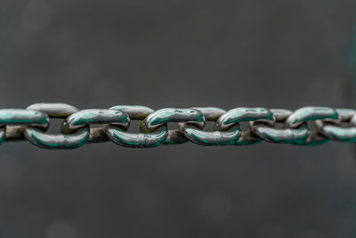 Close up of chain against a blue background