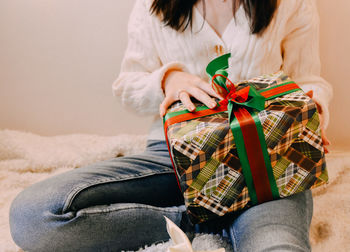 Midsection of woman holding gift