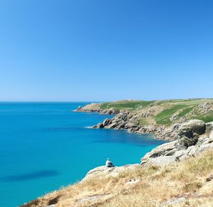 Scenic view of sea against clear blue sky