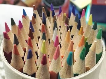 Close-up of multi colored pencils on table