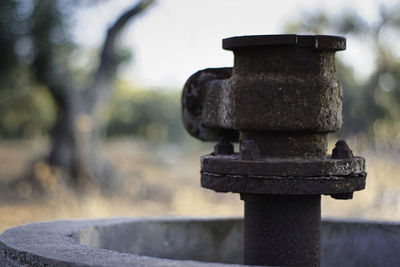 Close-up of old rusty metal on field