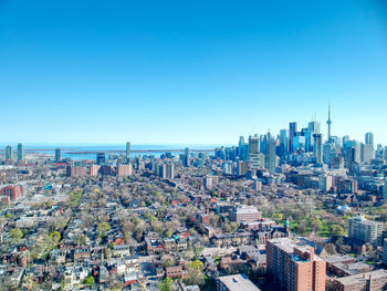 High angle view of modern buildings against clear blue sky