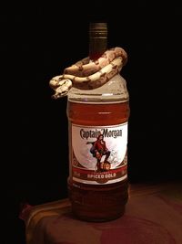 Close-up of drink in jar on table against black background