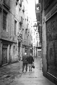 People walking on alley in city
