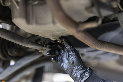 Cropped image of man repairing car