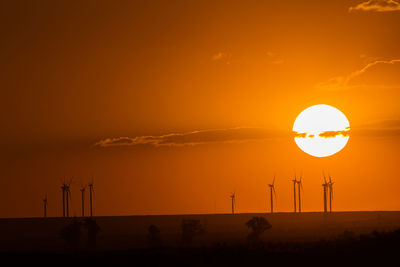 Wind turbines in rural landscape at sunset