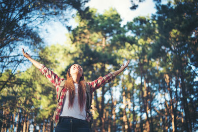 Full length of person standing by tree in forest