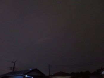 Low angle view of silhouette building against sky at night