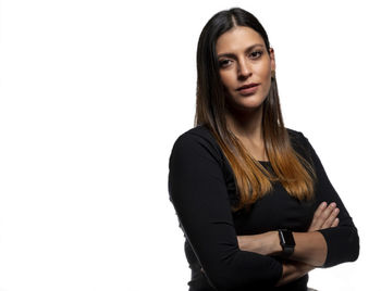 Portrait of beautiful young woman against white background