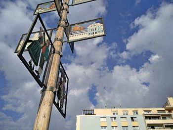 Low angle view of road sign against sky