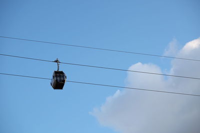 Low angle view of cables against blue sky