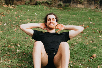 Portrait of smiling young man exercising outdoors