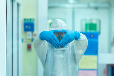 Portrait of man gesturing in laboratory