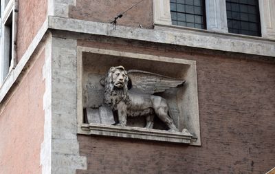 Low angle view of lion statue on building