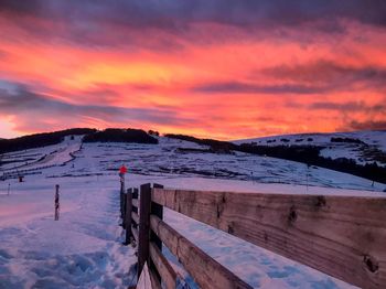 Scenic view of snow covered mountain against dramatic sky