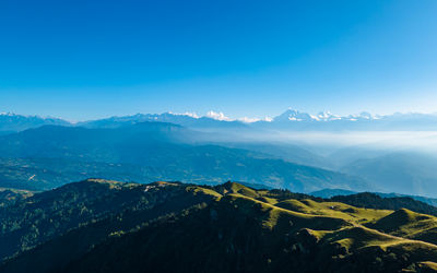 Scenic view of mountains against clear blue sky